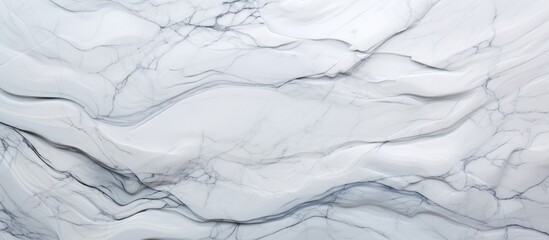 Naklejka premium Detailed view of a white marble texture, showcasing intricate patterns and veining characteristic of this luxurious material. The surface reflects light, creating a smooth and elegant appearance.