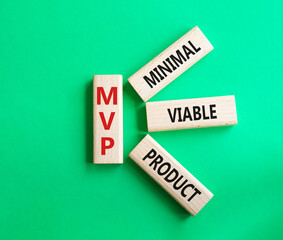 MVP - Most Valuable Player symbol. Wooden cubes with words MVP. Beautiful green background. Business and MVP concept. Copy space.