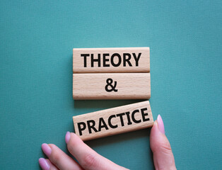 Theory and Practice symbol. Concept word Theory and Practice on wooden blocks. Businessman hand. Beautiful grey green background. Business and Theory and Practice concept. Copy space