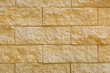 Beige stone blocks in the wall