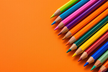 Colored pencils stand boldly against an orange background, their hues and shades contrasting and complementing the warm backdrop, creating a visually stimulating composition that celebrates creativity - obrazy, fototapety, plakaty