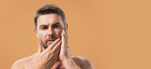 Closeup portrait of attractive man with cream on face. Beautiful man close up portrait on white...