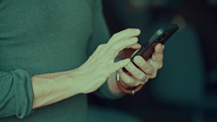 Close-up of a man hands texting on a phone - 754537397