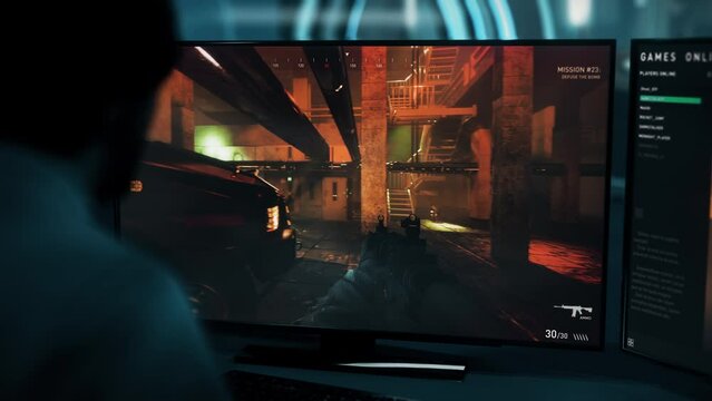 Gamer Defuses Bomb Planted By Terrorists To Win Level In Modern Shooter Game. Gamer Playing Shooter Game Against NPC Enemies. Gamer Controls Special Forces Character In Shooter Game. Victory