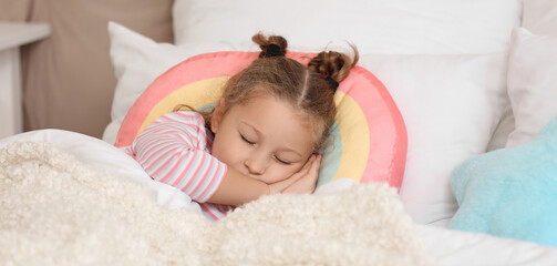 Cute little girl sleeping in bedroom