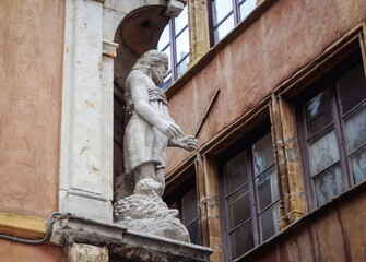 Statue on house at Rue Saint-Jean on Old Town in Lyon city, France