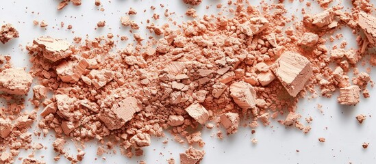 Detailed view of a pile of beige powder on a white table, showing texture and color contrast.