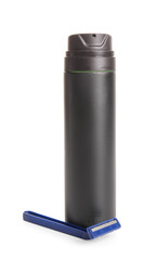 Bottle of shaving foam with razor isolated on white background