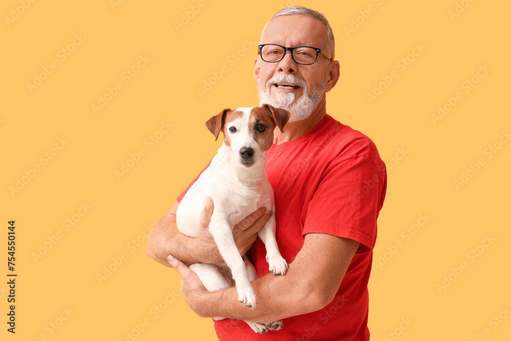 Sticker Portrait of senior man with cute dog on yellow background