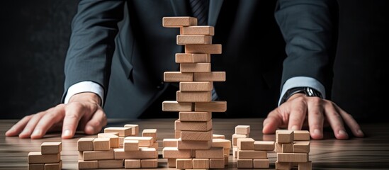 Businessman Strategically Stacking Wooden Blocks in a Smart Suit