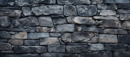 Obraz premium Rugged Stone Wall Texture on Dramatic Black Background - Industrial Urban Design Element