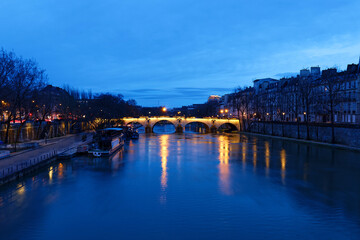 The view of bridge Ponte Marie over Seine river at night , Paris, France. It is one of the oldest bridges in Paris.