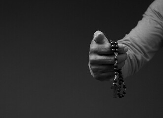 man praying to god with hands together on dark background with people stock image stock photo	