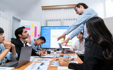 Project manager planning schedules for business task at meeting room, Gantt chart software show on...