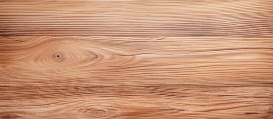 Fototapeta premium Detailed close-up view of a light brown, natural wooden surface. The texture of the timber is visible, showcasing the unique patterns and variations in the wood. Whether used as a plank, flooring,