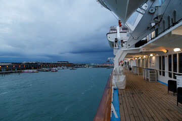 View of the Cruise Port of Venice from the open deck of the passenger cruise ship, evening, cloudy weather. Travel concept