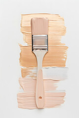 A paint brush rests on a beige rectangle of wood with magenta paint strokes