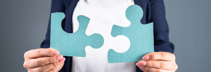 Woman holding puzzle pieces
