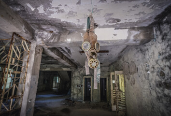 Old gas mask in Middle School No. 3 in Pripyat ghost city in Chernobyl Exclusion Zone, Ukraine - obrazy, fototapety, plakaty