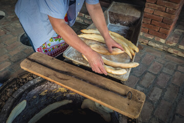 Woman makes Georgian bread called Shotis puri in Napareuli village, Georgia