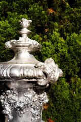 Obraz premium Silver antique vase on a green background.