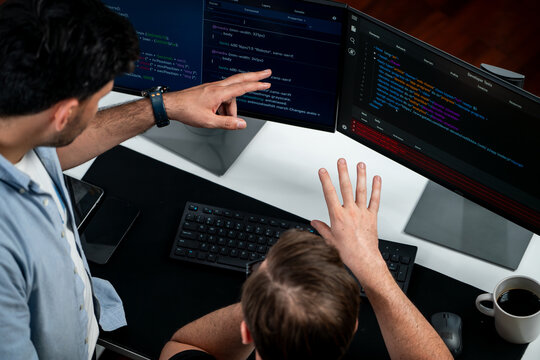 IT developers discussing online software development information on pc screen, creating program coding for latest version application on website. Concept of brainstorming firmware updated. Sellable.