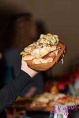 Wooden dish with sliced appetizer for aperitif alcohol in restaurant