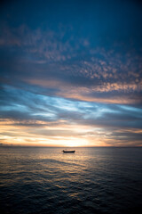 sunset over the sea and a boat