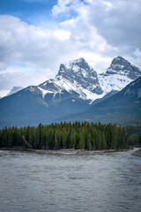 Canadian snow covered mountains with river and trees