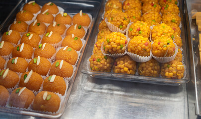 Traditional Indian sweets and desserts in pastry shop and street food on markets