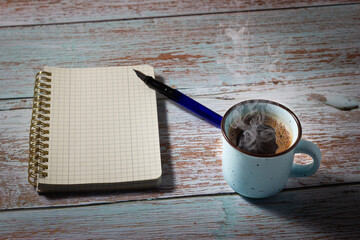 Creation process with a notebook, a fountain pen and a cup of freshly brewed coffee. Concept of...