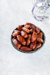 Dates Fruits and Glass of Water on Concrete Background, Ramadan Suhoor Concept, Copy Space