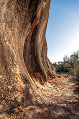 Elachbutting Rock in the eastern Wheatbelt region of Western Australia is a spectacular natural granite rock formation. An outback monolith with caves and a wave shaped wall.