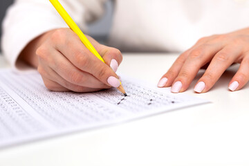 Hand filling in an Examination form.