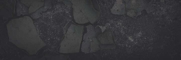 Dark wide panoramic background. Peeling paint on a concrete wall. Faded dark texture of old cracked...