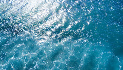 Fototapeta premium Abstract image from top view of wave on clear blue sea surface glitter in sunlight