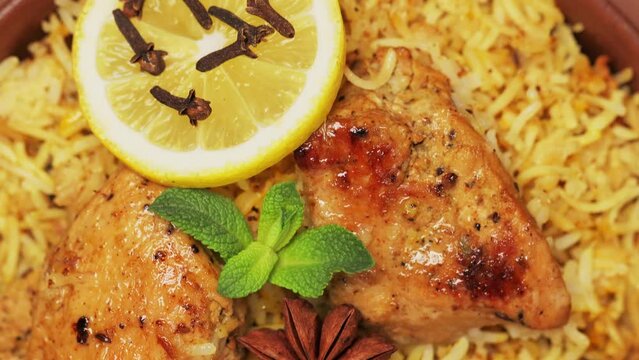 Indian Chicken Biryani with Aromatic Spices in Bowl, Tilt Down Camera Movement