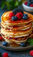 Delicious homemade american pancakes with fresh berries and honey on white background