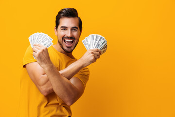 Man money surprised hand currency dollar happy rich background yellow success finance business smiling cash - obrazy, fototapety, plakaty