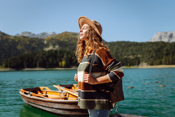 Young female tourist enjoys nature. Lifestyle, travel, tourism, nature, active life.