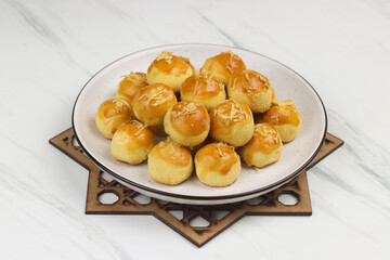 Kue Nastar or Pineapple tart cookies, Indonesian popular cookies during lebaran or hari raya, Eid al fitr and Eid al Adha. Ramadan Islamic theme for text and background.

