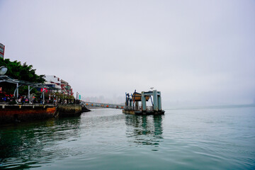 Bali, New Taipei, Taiwan, Republic of China, 01 22 2024: Cruise ferry boat and port on Clean Tamsui river in a raining day in winter
