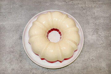 Top view of a cream cheese gelatin with a layer of strawberry flavor gelatin with real strawberries.