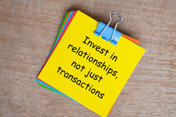 Invest in relationships, not just transactions text on yellow notepad.Business relationship concept.
