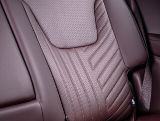 Part of leather car headrest seat details. Сlose-up brown  perforated leather car seat. Skin...