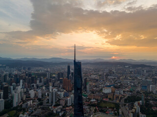 Aerial golden sunrise at Kuala Lumpur city skyline.