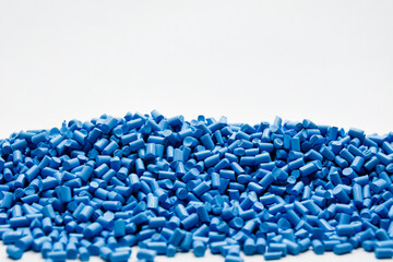 blue masterbatch granules on a white background, this polymer is a colorant for products in the...