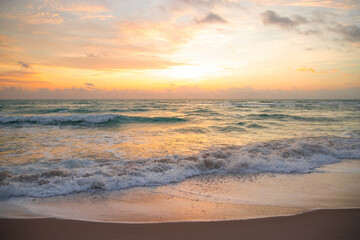 Dramatic sunrise horizon, yellow sky, turquoise sea waves