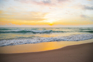 Fototapeta na wymiar Sunrise horizon, soft sky, turquoise sea waves