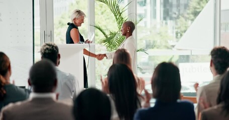 Award, handshake and congratulations with woman talking to audience or crowd at formal business event. Meeting, workshop or ceremony and applause of group of professional people at prize giving